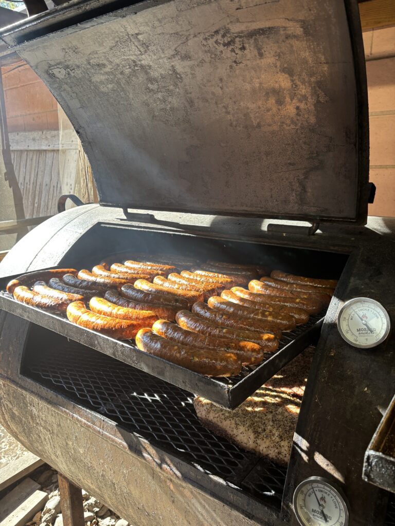 Sausages and briskets are on the grills at Tejas Chocolate + Bar-B-Q in Tomball. (Photo by Laura Landsbaum)