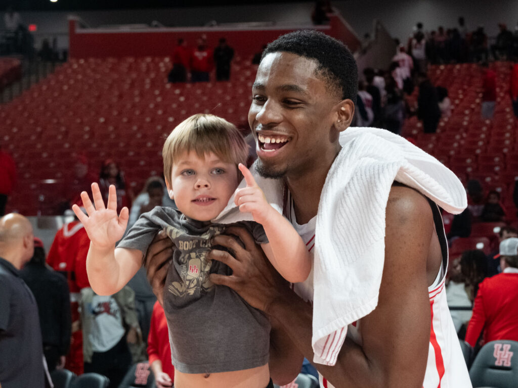 University of Houston guard Terrance Arceneaux makes a young Cougar fan's day. (Photo by F. Carter Smith)