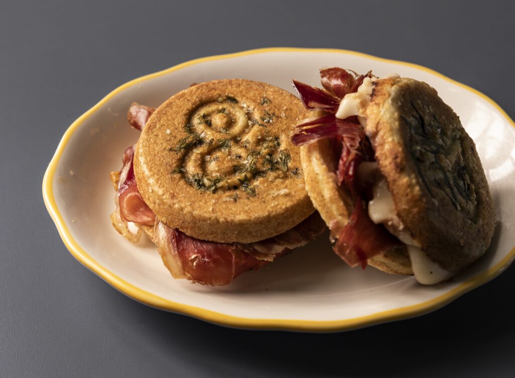 Lee's tigelle pressed sandwich is a housemade flatbread similar to an English muffin layered with ham, sliced apples, honey, and taleggio cheese ($11). (Photo by Julie Soefer)