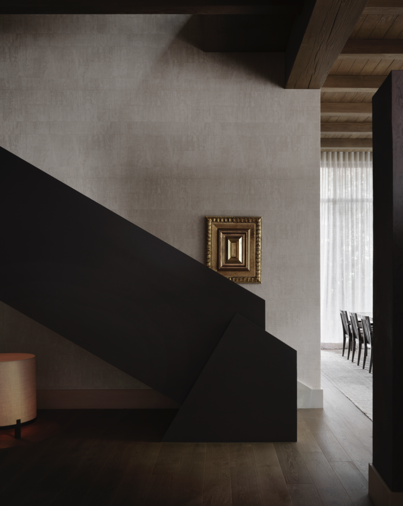 In the entry of the house he shares with partner Mauricio de la Garza, architect and interior designer Mauricio Lobeira contrasted textural materials and shapes including Élitis wallpaper from George Cameron Nash, wood beams, a custom steel staircase of his design, and Vitoli wood floors. Artwork is by Kolkoz. (Photo by Douglas Friedman)