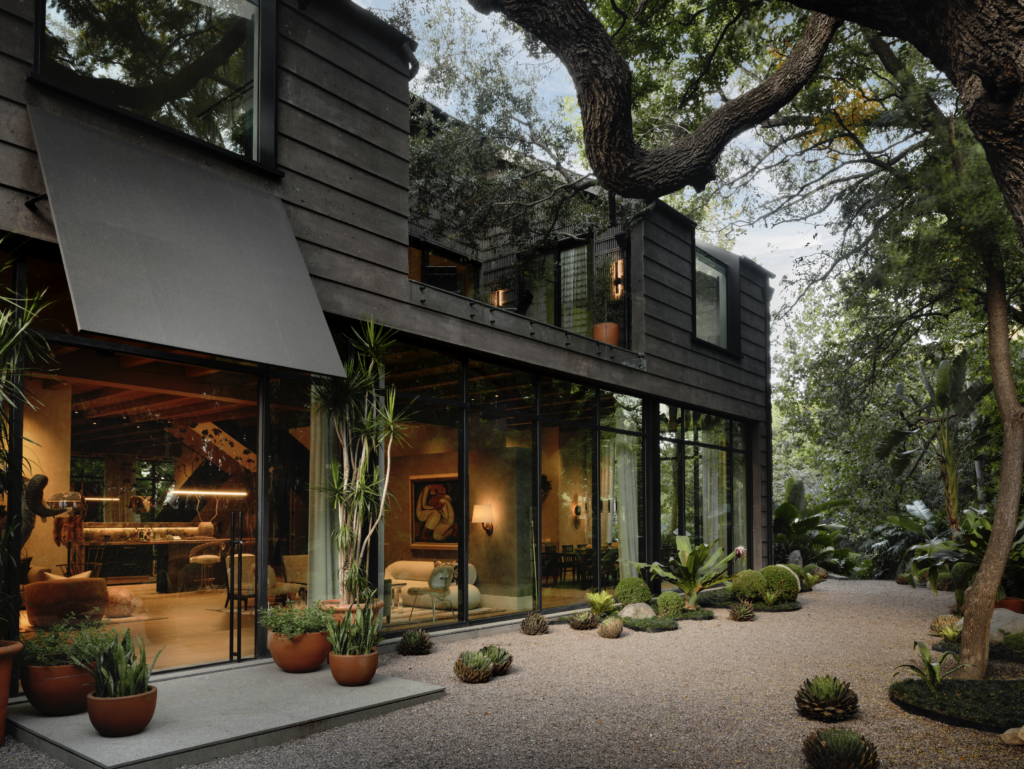 The house is clad in Mexican limestone, which took artisans two years to cut and carve into Aztec-inspired patterns. Mauricio de la Garza of Dornato designed the gardens to blend with the surrounding park. (Photo by Douglas Friedman)