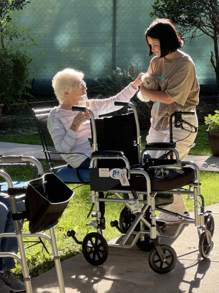 A resident of Signature Pointe visiting "the girls," part of her new daily routine.