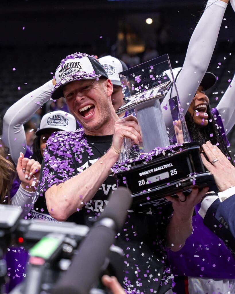 TCU head coach Mark Campbell celebrates with the Big 12 Championship trophy after leading the Horned Frogs to their first conference title in program history. (Photo by TCU Athletics)