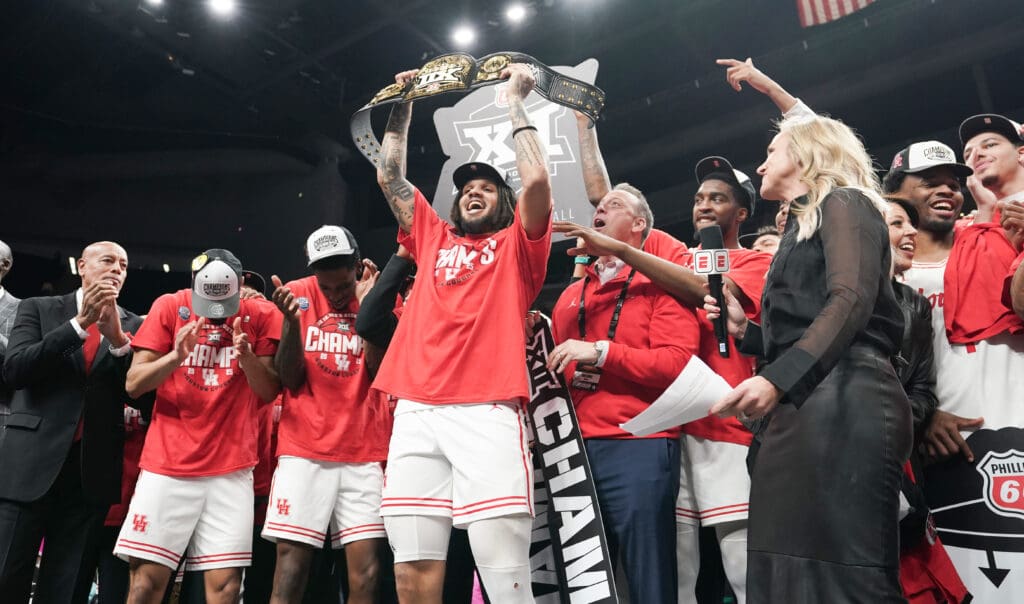 Emanuel Sharp had some fun holding up the championship belt for winning Big 12 MOP. But its his health that’s the biggest thrill for Kellvin Sampson’s University of Houston team.  (Photo by Denny Medley/Big 12 Conference)