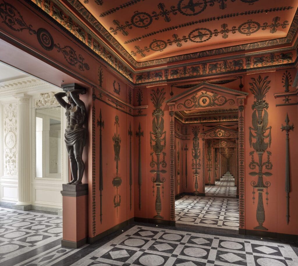 In the vestibule of Féau Boiseries headquarters in Paris, the elaborate hand- carved Etruscan-style rooms were inspired by the original neoclassical decor designed for Napoleon by architects Charles Perrier and Pierre-François Fontaine.