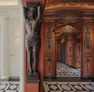 In the vestibule of Féau Boiseries headquarters in Paris, the elaborate hand- carved Etruscan-style rooms were inspired by the original neoclassical decor designed for Napoleon by architects Charles Perrier and Pierre-François Fontaine.