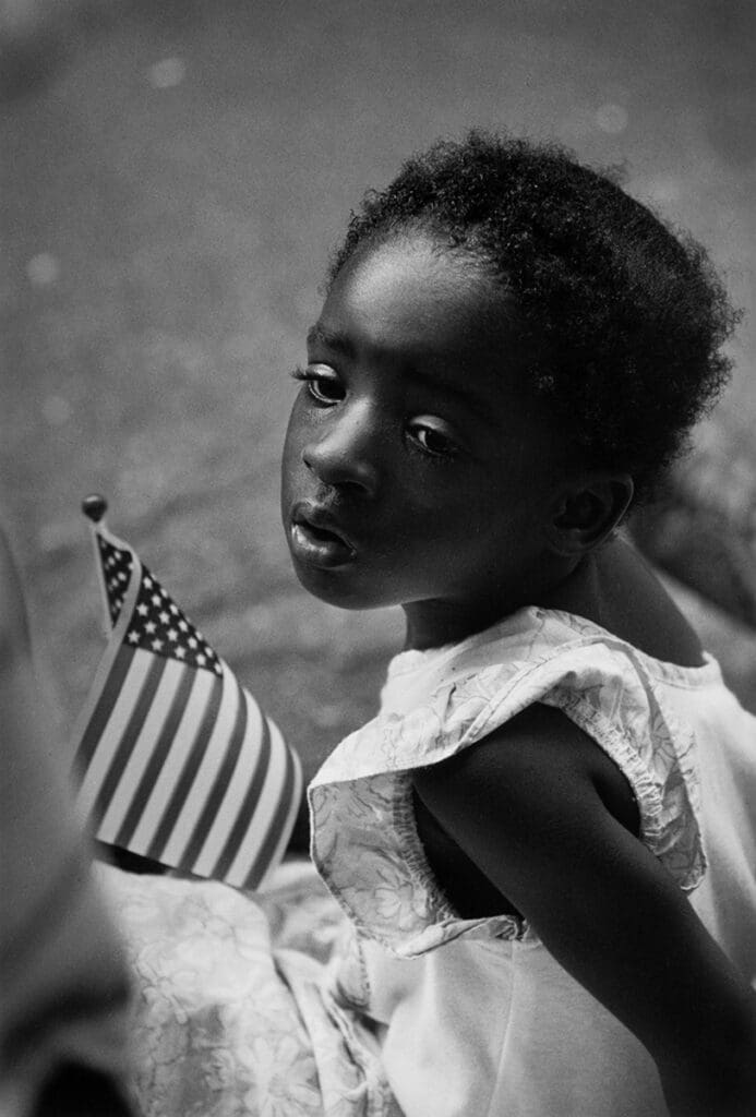 Earlie Hudnall Jr's "Girl with Flag," 1991, at PDNB Gallery. Hudnall holds 2022 Lifetime Achievement honors from Art League Houston for his sensitive take on Black life in his hometown of Houston. 