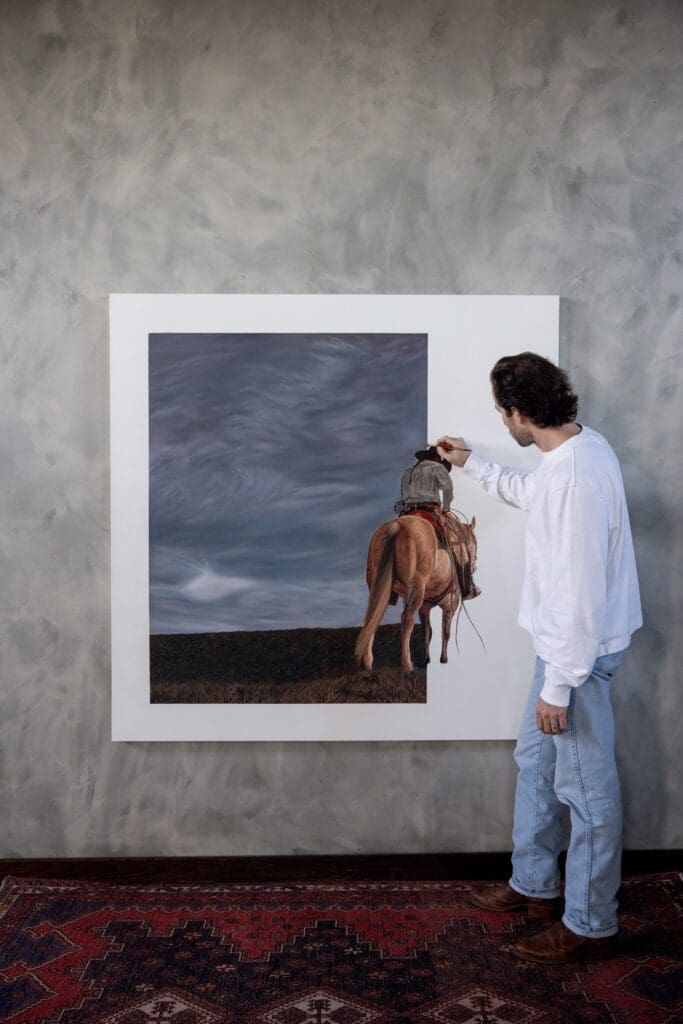 Lovett adds details to his piece. (Photo by Gallery at Bowie House)