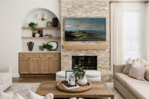 The fireplace serves as the focal point of the family room in this Cochran Crossing's home, with the television now centered above and custom shelving styled for warmth. (Photo by Madeleine Harper)