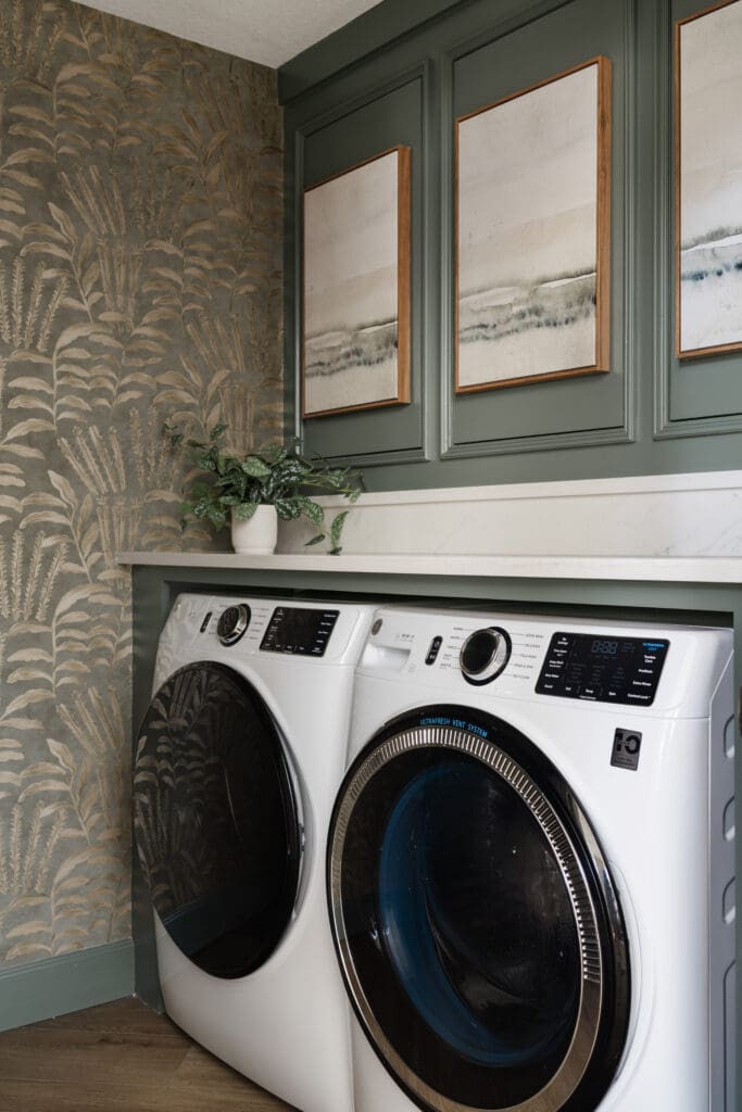 A bold topiary wallpaper adds color and character to the laundry room, complementing the fresh paint and built-in storage. (Photo by Madeleine Harper)