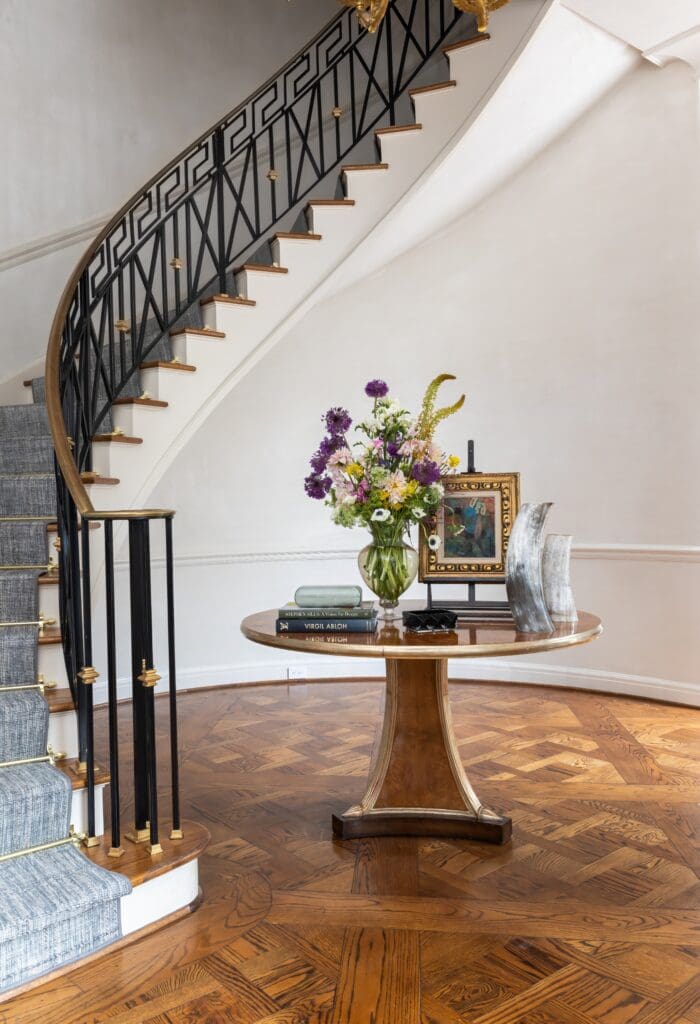 The sweeping staircase that welcomes guests to the foyer of the River Oaks home.(Photo by Laurie Perez)