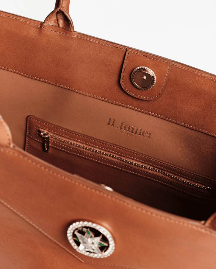 The sleek interior of an 11 Juillet bag in ecru.