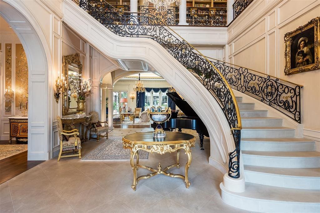 In Old Preston Hollow, this French Renaissance-inspired estate sits on over two acres and features a two-story domed entry with a stunning floating staircase. (Courtesy)