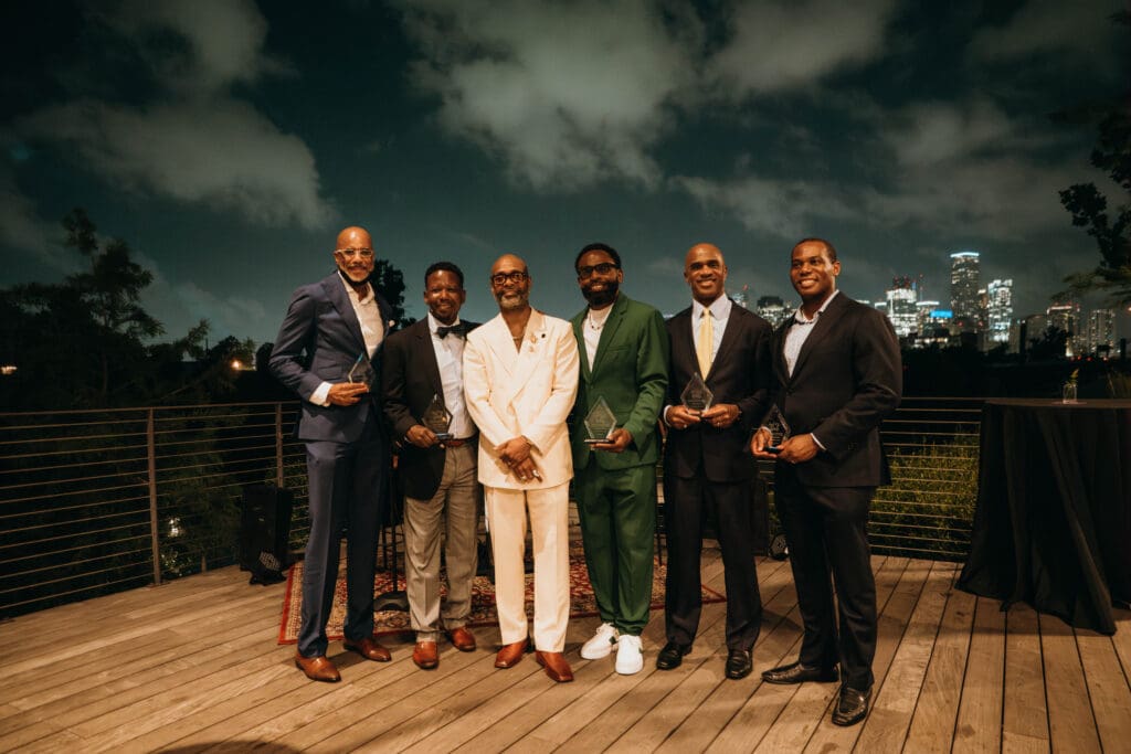 CoolxDad CEO, Kevin Barnett (white suit), with Robert A. Bowser Real Time Award winners Ed Ryland, Philip Yates, LaRonn Harris, Chris Porter, and Quentin Smith at the 2025 An Evening in Real Time benefit. (Photo by William Issac)