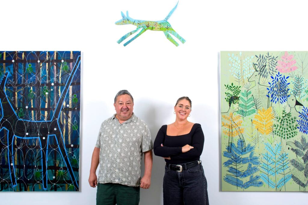 Artist Gerardo Rosales and Laura Burton come together underneath his "Feroz" piece, at Laura (the gallery).