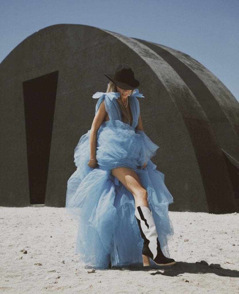 Owner Chaz Pilarcik models a pair of her modern cowgirl boots. (Courtesy)