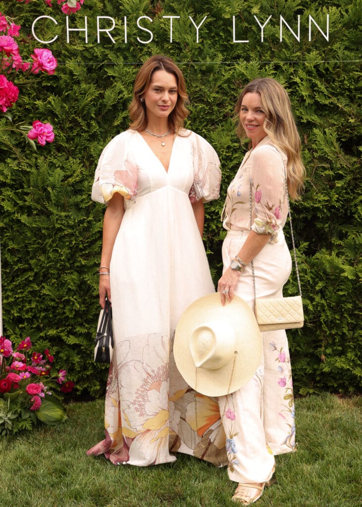 Ukranian attorney Olesya Stefanko, Compass real estate agent Chelsea Baetz, both of New York, at the Christy Lynn poolside luncheon in Southampton, New York (Photo by BFA / Kevin Czopek)
