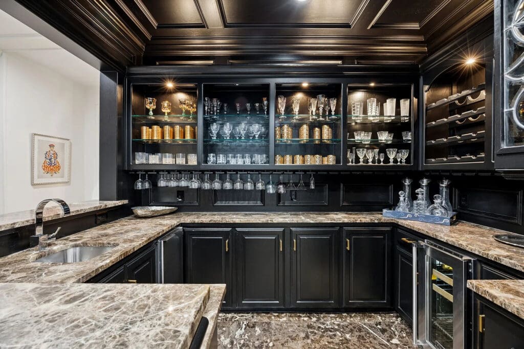 A black marble walk-in bar leads into a relaxing lounge. (Photo by Allie Beth Allman & Associates)