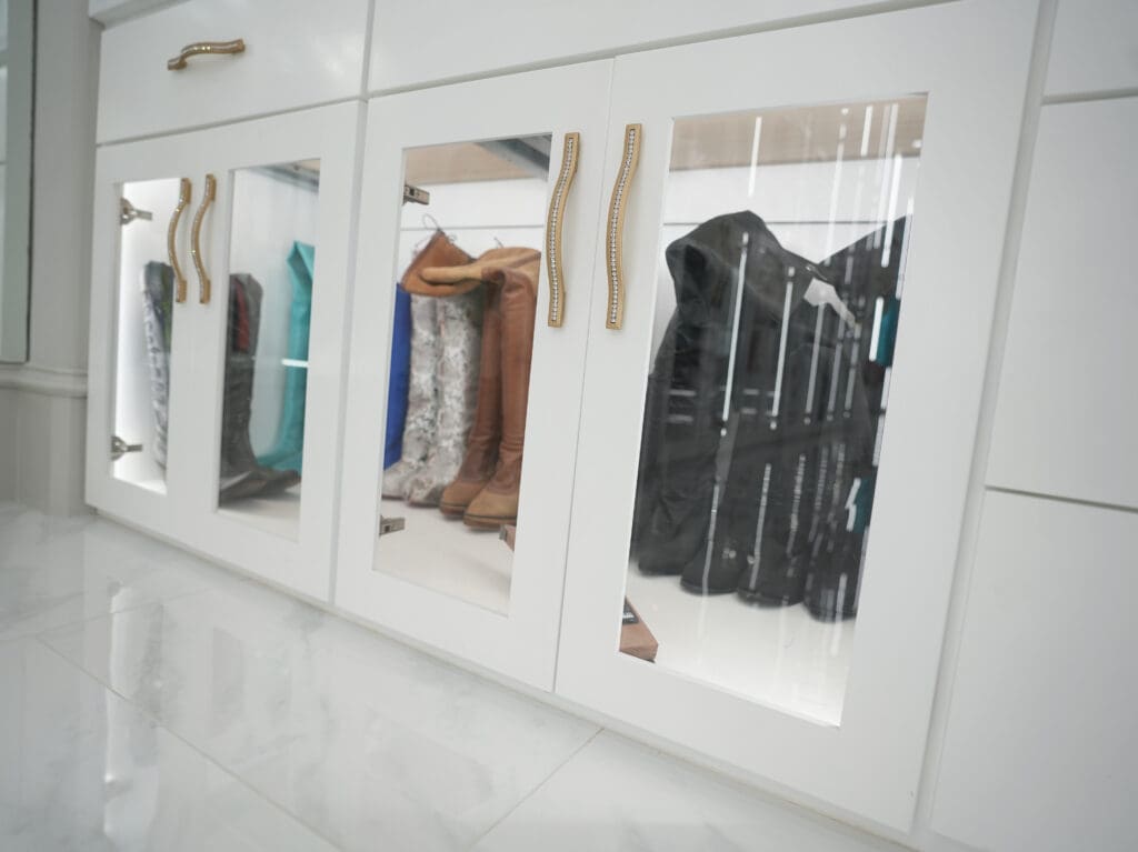 Boot storage in the closet is at floor level, behind glass doors.