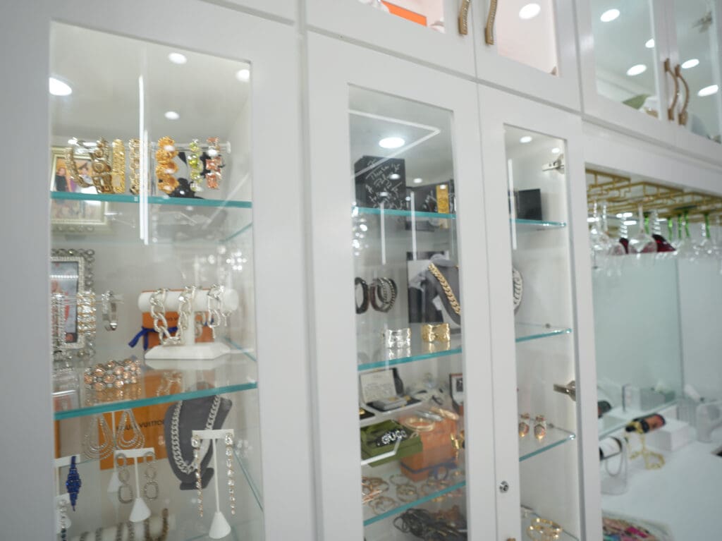 Jewelry cabinets flank either side of the champagne bar area.