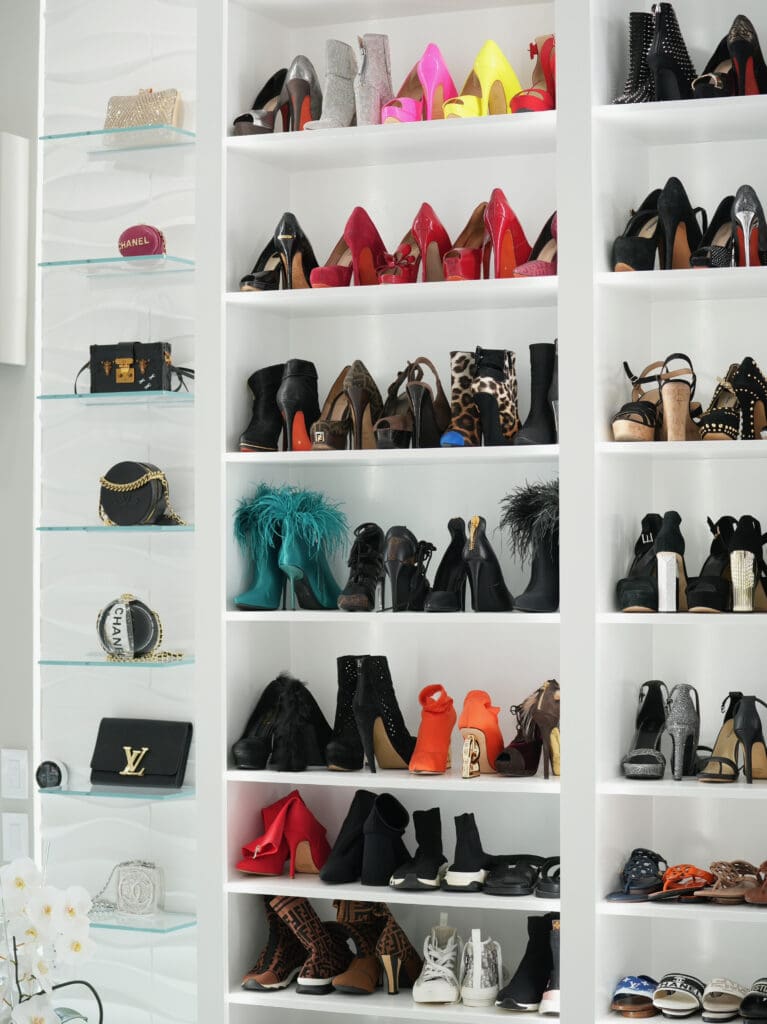 Shoes are stored on wooden shelves, and are in full view for easy access.