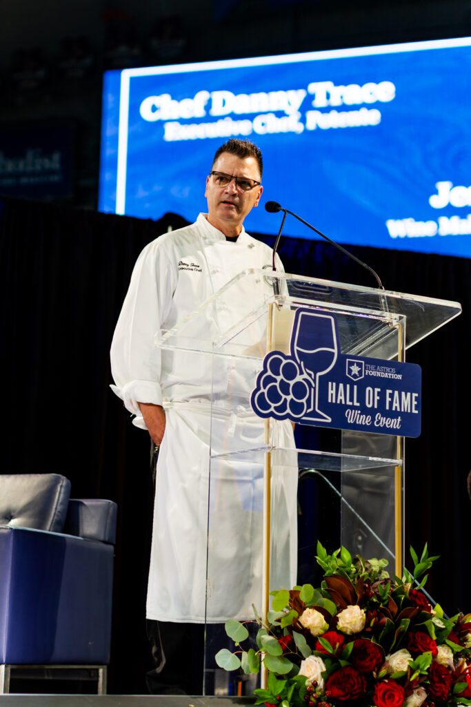 Potente Chef Danny Trace introduces his multi-course gourmet dinner  at the Houston Astros Foundation Wine Dinner on the field at Daikin Park. 