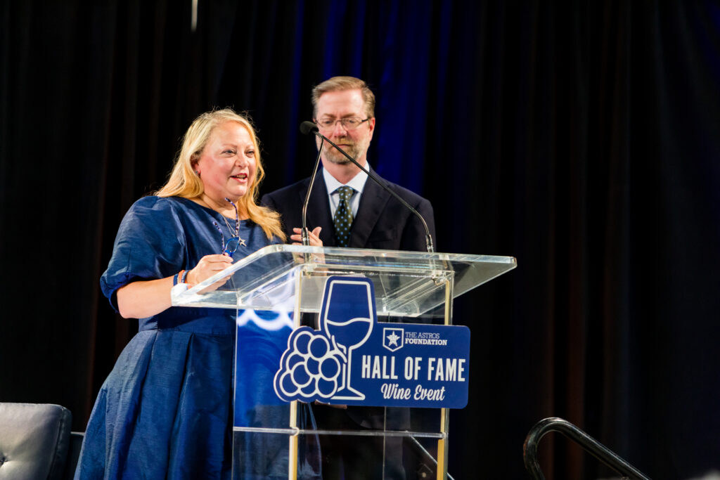 Houston Astros Foundation Hall of Fame Wine Dinner chairs Allison and Geoff Leach on the field at Daikin Park. 