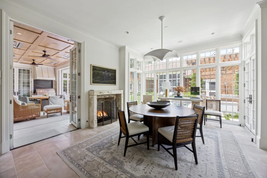 Many of the gathering rooms lead to charming outdoor spaces, from the breakfast room with floor-to-ceiling boxed windows that opens to an outdoor loggia, to the study, which opens to a side patio. (Photo by Full Package Media / Compass)
