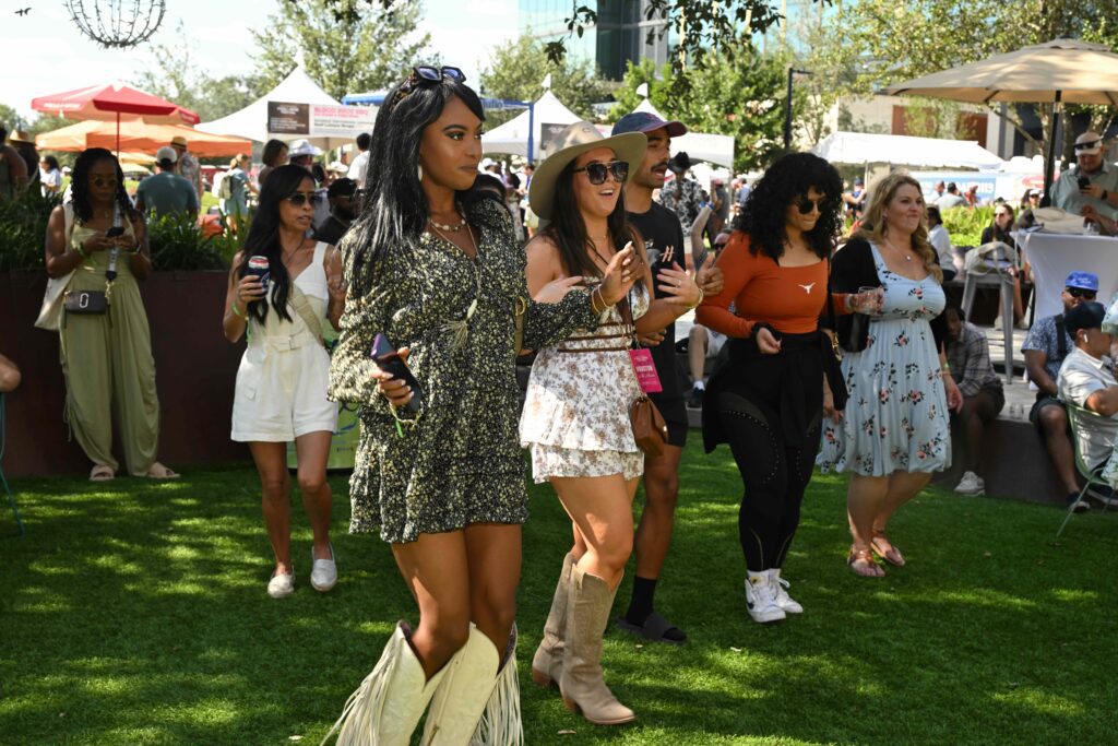 In addition to grazing and quenching thirsts, some guests found themselves line dancing at the Houston Chefs for Farmers. (Photo by Jack Opatrny)