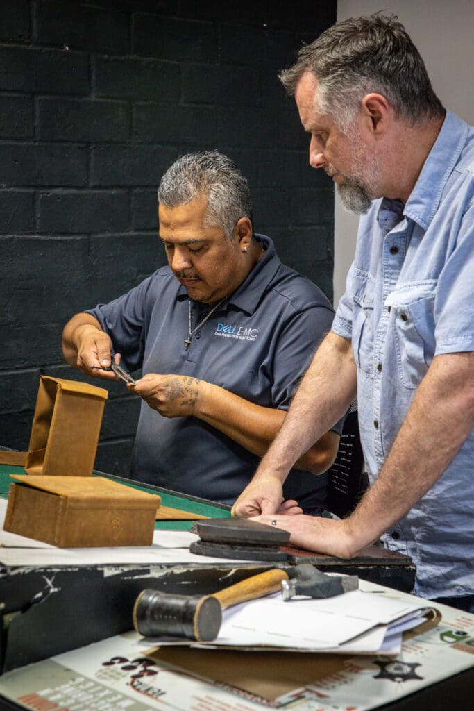 Munson (right) stands alongside a craftsman at the company’s León factory, where every piece is handmade with meticulous attention to detail. (Photo by Saddleback Leather Co. )