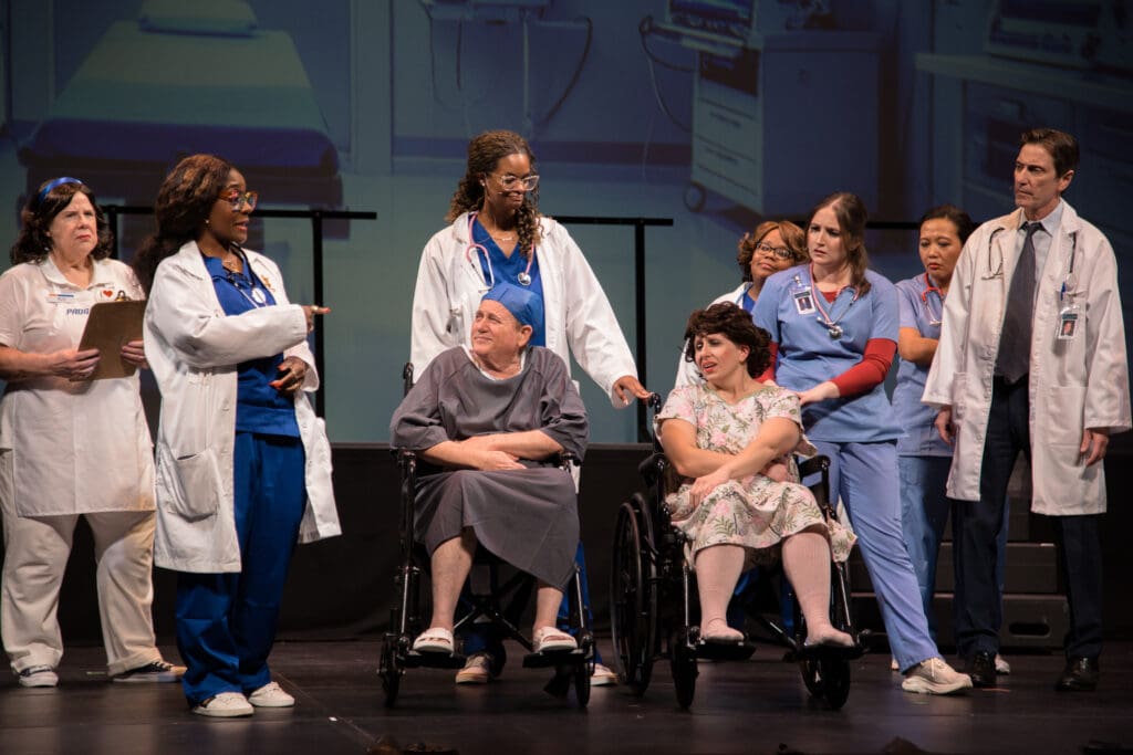 Marilyn Brown as Flo the Insurance Rep, Uchenna Paul as Dr. Scholls, Veronica Jones as Dr. Pepper, Mark Goldberg as Andy Appendectomy, Dana Lizik as Alice Appendectomy, Elizabeth “Peaches” Lockett as Dr. Bailey, Bri Holcombe as Dr. Meredith Grey, Yoka Larasati as Dr. Yang and Marshall Campbell as Dr. McDreamy in Night Court's "Law’s Anatomy: The Juris Doctor Will See You Now" (Photo by Ricornel Productions)
