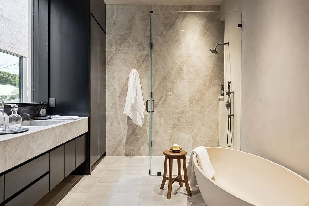 The primary bath pairs clean lines with a soaking tub and walk-in shower for a spa-like retreat. (Courtesy)