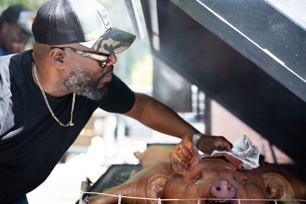 Famed South Carolina pitmaster chef Rodney Scott tends to his BBQ. Hugh Galdones Photography.