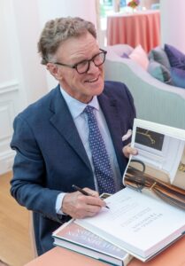 Russell Windham signs at Curtis & Windham Architects book signing. (Photo by Jordan Geibel)