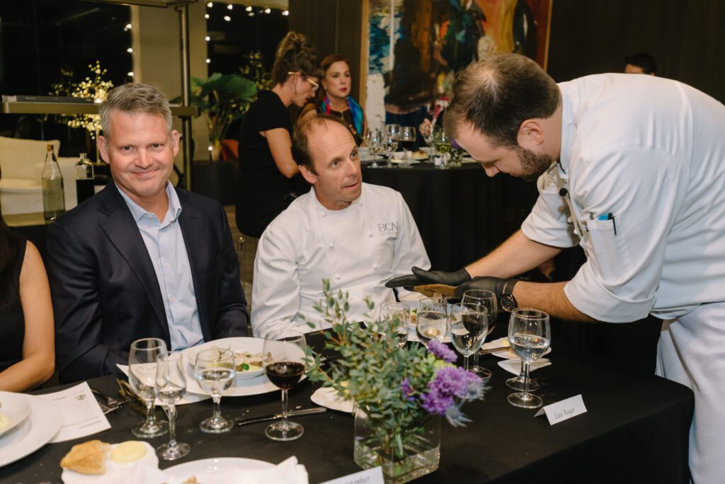 Chef Felipe Botero grades truffles for Chef Luis Roger at the BeDesign Chef Series No. 2 while architect Christopher Robertson looks on.