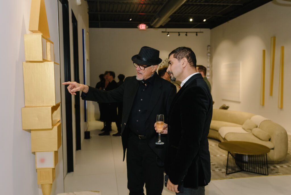 Artist McKay Otto discusses his work on display in a gallery on the third floor of BeDesign