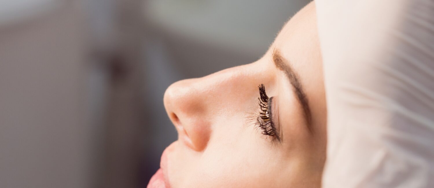 Hands of doctor examining womans face for cosmetic treatment at clinic