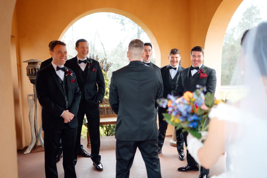 The groomsmen got the first look at Gracie, just before Ethan turned around.
