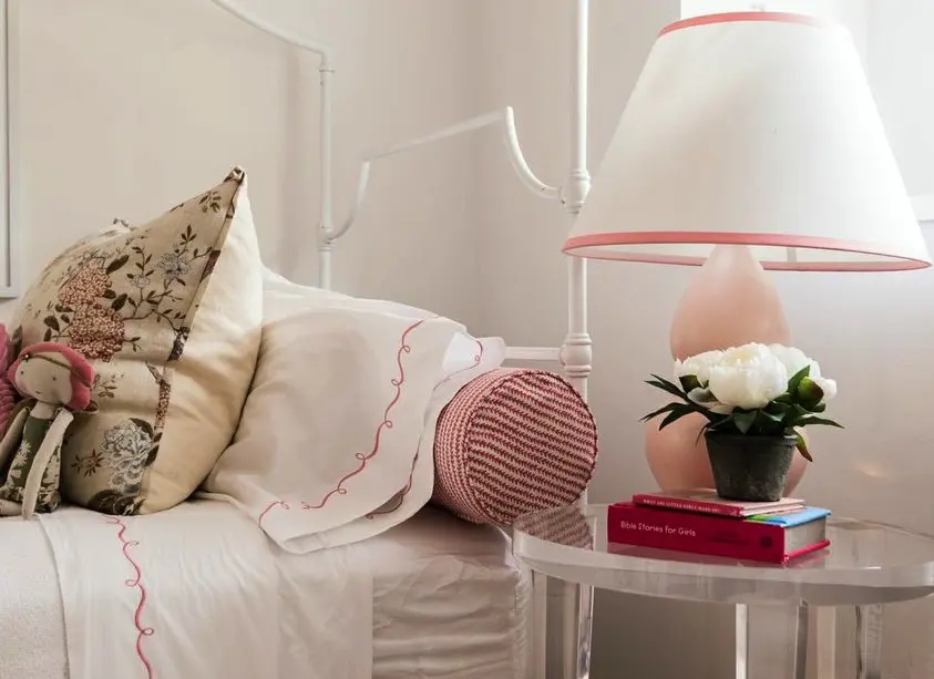 Girls room: bed from Pottery Barn, lamp from Arteriors, bedding from Horchow, Emerson Sloan Angel doll and pillow (fabric) from Lee Jofa.