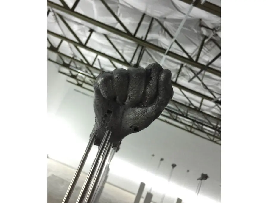 An enigmatic fist, one of many, rises in the Haines Riddick Gallery of the epic Loris Gréaud installation.