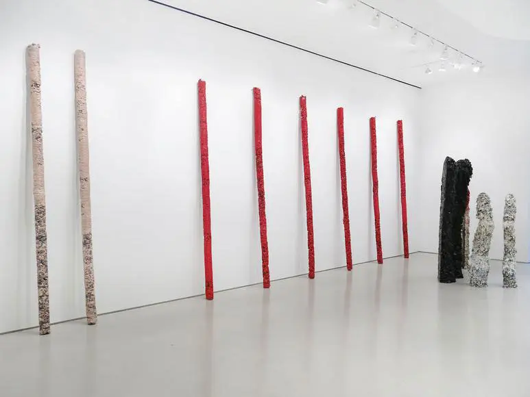 Approximately 200 resin-and-pigment totems stand like ghostly presences.  