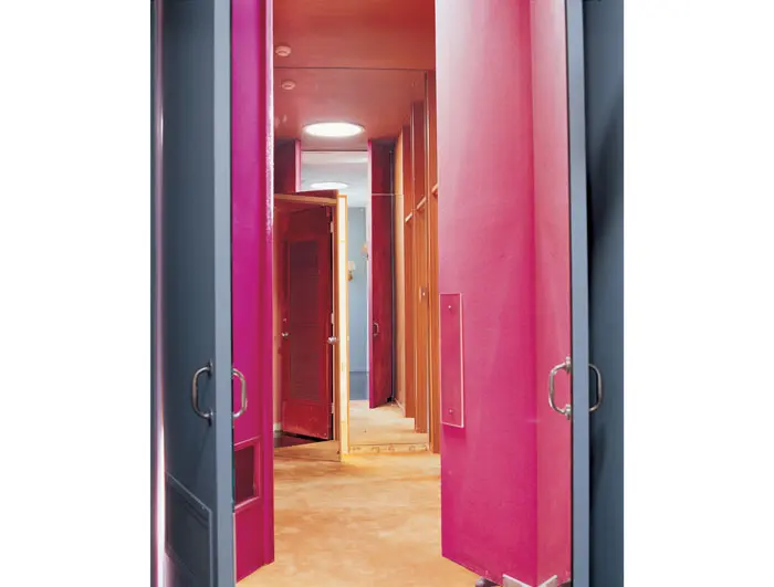Mimicking a funhouse effect, myriad doors in the children's wing were covered by Charles James with mirrors, lush, antique magenta velvet and fun pops of hot-pink felt. 