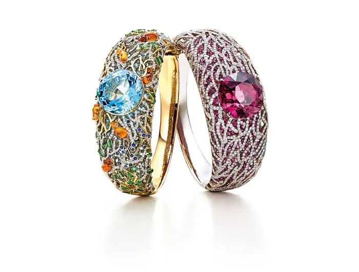 Bracelet with a 21.04-carat round aquamarine in a sea of mixed-cut gemstones, including spessartites, tsavorites, sapphires and diamonds with an underlay of aquamarines in 18K yellow and white gold; bracelet with a 32.05-carat cushion-cut rubellite and an underlay of pink sapphires, with diamonds and 18K white gold in a coral motif