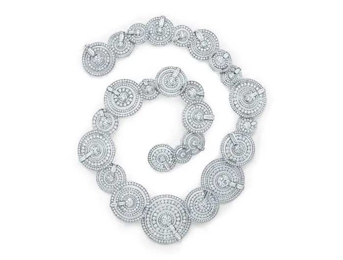 Necklace of whirlpools of baguette and round diamonds designed to flow along the neckline