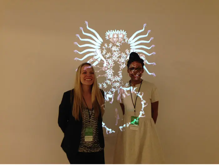 Newcomer to the Fair, Dallas' Zhulong Gallery presented projections by Renee Cox. Shown: Zhulong's Jessica Ingle and Aja Martin. 