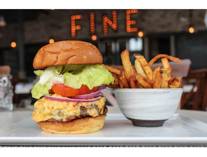 Low Country Burger at Bradley's Fine Diner. Crispy gaunciale, kale, pimento cheese and hand-cut fries at Bradley's Fine Diner. Photo courtesy Andrea Weir. 
