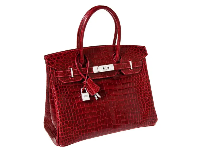 This striking Hermès Shiny Rouge H Porosus Crocodile, 30-cm. Birkin Bag (with solid 18K white gold and diamond hardware) set a world Birkin record — $203,150 — when it went on the block at Heritage, December 6, 2011, in Dallas. 