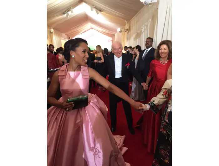 Kerry Washington, wearing Prada, behind us on the red carpet 
