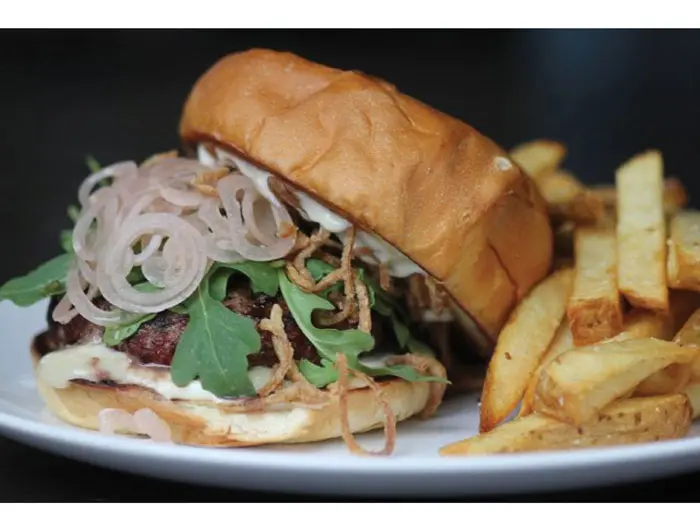 The Juicy Lucy at Lowbrow. Trill Texas angus beef
stuffed with jalapeños and fontina cheese, topped with arugula, crispy shallots and pickled shallots on 
Slowdough challah bun. 
