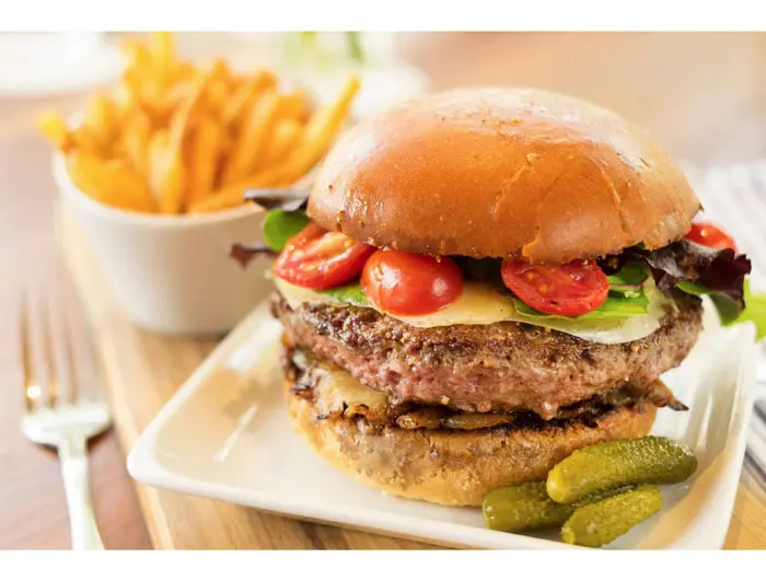 Le Cheesburger at Bistro Menil featuring caramelized onion, gruyere, roasted tomatoes and dijonnaise. 